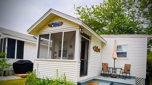 A small, single-story house with a covered porch and a small deck. - Sea Bisquit Cottage by the Ocean (Scarborough)