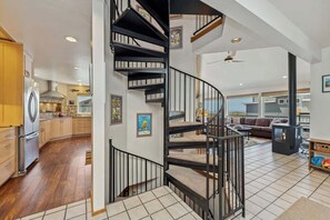 A modern kitchen with wooden cabinets, a stainless steel refrigerator, and a built-in oven. - Beaches N' Greens by Manzanita Beach Getaway - Ocean Views & Wraparound Deck (Manzanita)