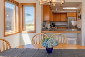 Enjoy cooking in this well-equipped kitchen with a large island, oven, and dining table.