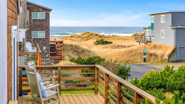 A coastal property with a wooden deck, outdoor seating, and a view of the ocean. - Forever Manzanita by Manzanita Beach Getaway: Ocean View, Dog-Friendly, Hot Tub (Manzanita)