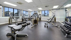 A gym with various exercise equipment, large windows, and a clean, modern design. - 3919 Orlando Vacational Apartment (Orlando)