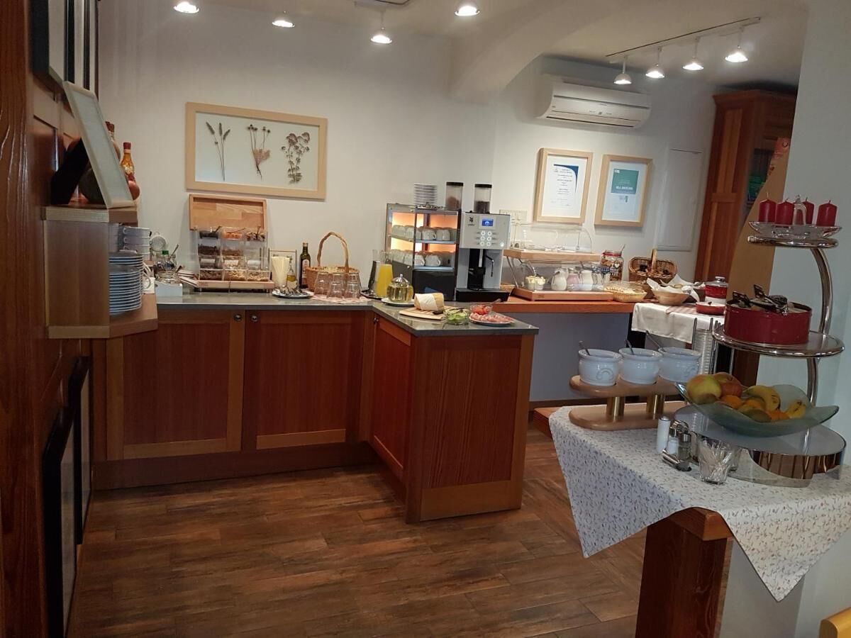 A modern kitchen with wooden cabinets, a central island, and a breakfast bar.