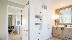 A modern bathroom with a large mirror, white cabinetry, and a wooden vanity. - Renovated! Wine Country Gem, 1 bed/1 bath + Sleeper Sofa, Sleeps 4! (Napa)