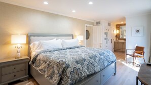 A bedroom with a bed, bedside lamps, a chair, and a desk. - Renovated! Wine Country Gem, 1 bed/1 bath + Sleeper Sofa, Sleeps 4! (Napa)