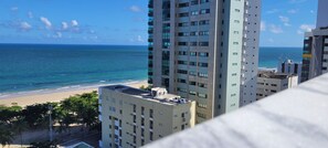 Stunning ocean views from this high-rise building, situated adjacent to the beach and surrounded by lush greenery.