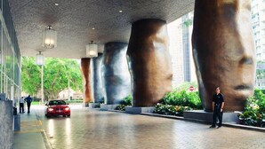 A modern building with large, abstract sculptures and a red car parked in front. - Studio in Miami/Brickell Business District-ICON Residences (Miami)