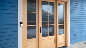 A wooden double door with glass panels, a metal handle, and a peephole. - The Haven on Halton (Perth)