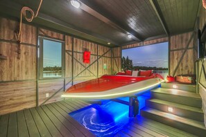 A wooden cabin with a hot tub, wooden walls, and a view of the outdoors. - Regal Royale at Reunion | Sleeps 30 | Pool, Theater & Game Room (Kissimmee)