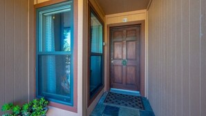 A wooden door with a number plate 'B1' and a window with a blue frame. - Oceanfront condo with PRIVATE deck. Pet friendly. Just a short walk to town. (Cayucos)
