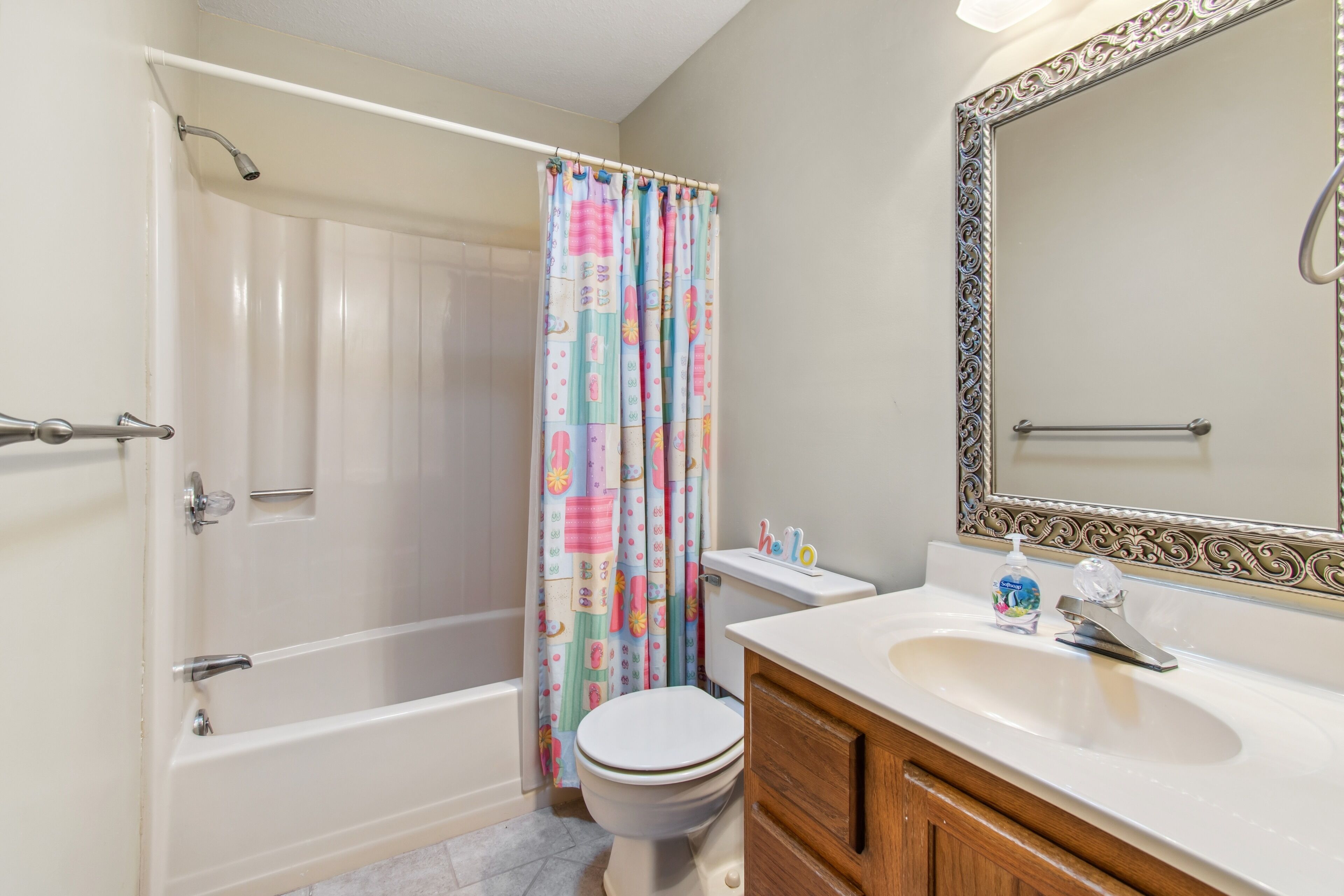 A bathroom with a bathtub, toilet, and sink.