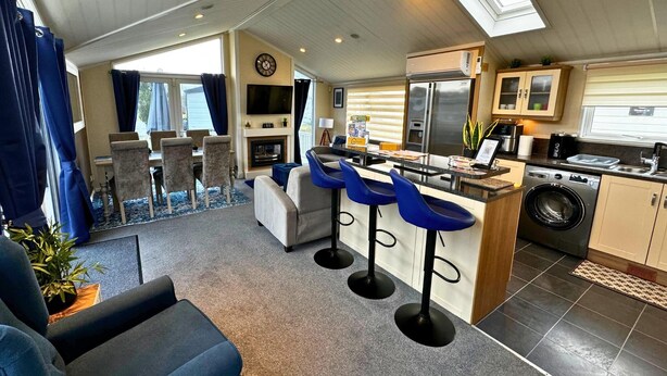 A compact living space with a kitchen, dining area, and a small seating area. - Sunset 5 -  Southview Holiday Park Skegness (Skegness)