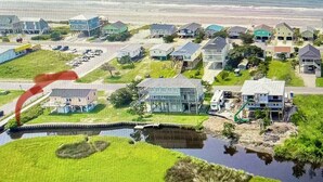A residential area with houses, a small bridge, and a body of water.