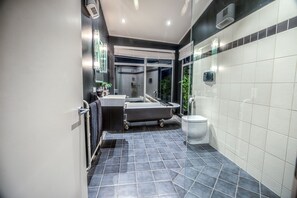 A modern bathroom with a bathtub, toilet, and sink. - ABSOLUTE BEACHFRONT LUXURY ACCOMODATION
Entire home with Private Beach Access (Karitane)