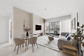 Relax in a stylish living room with a flat-screen TV, dining area, and comfortable seating.