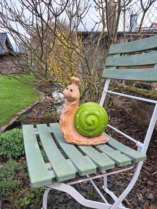 A bench with a snail sculpture.