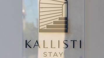 A sign with the text "KALLISTI STAY" and a stylized building graphic.