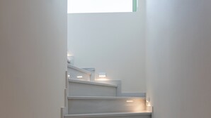 A staircase with a modern design, featuring a series of steps and handrails. - Kallisti Stay (Spata-Artemida)