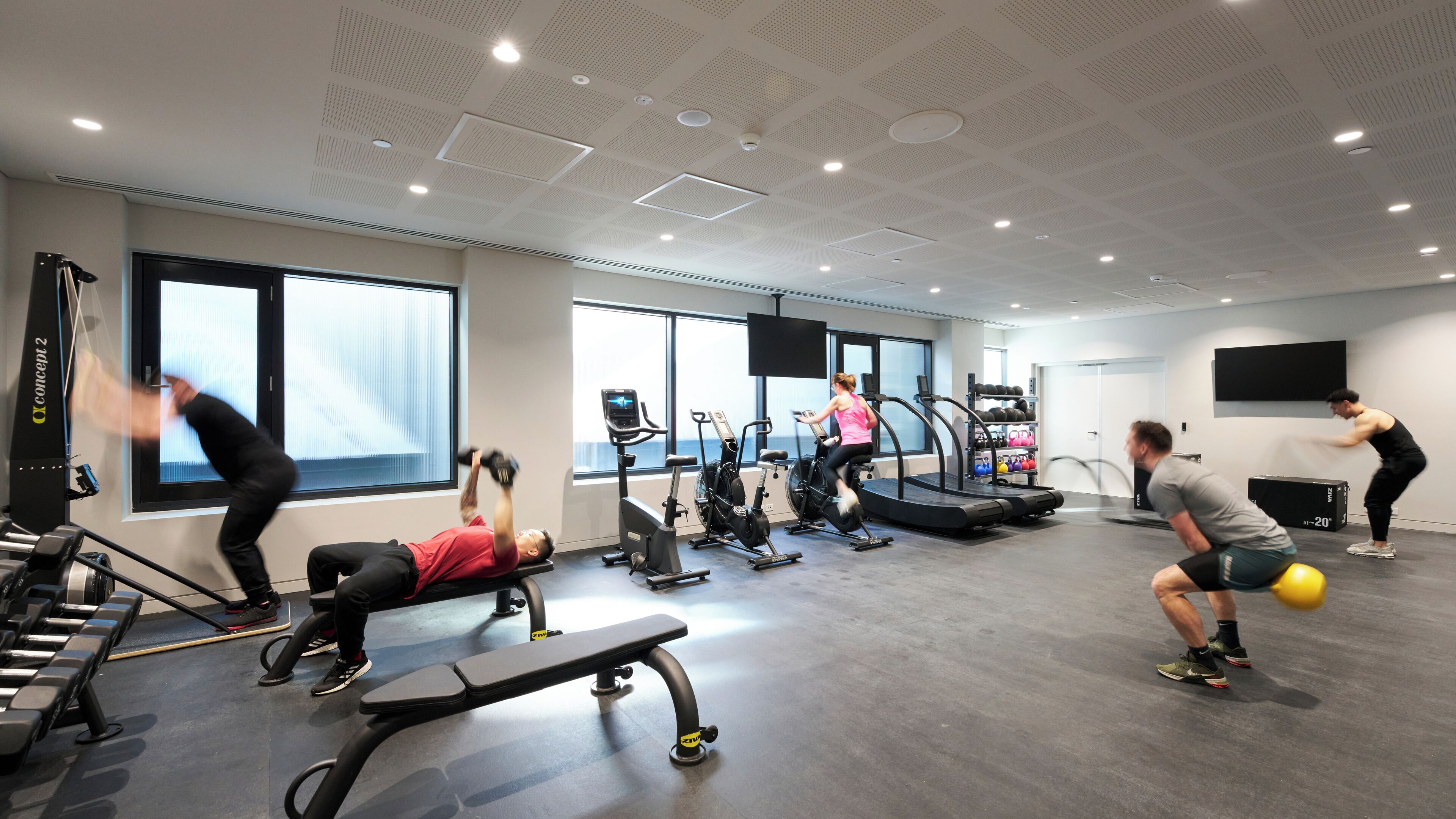 A gym with treadmills, stationary bikes, and weight machines.