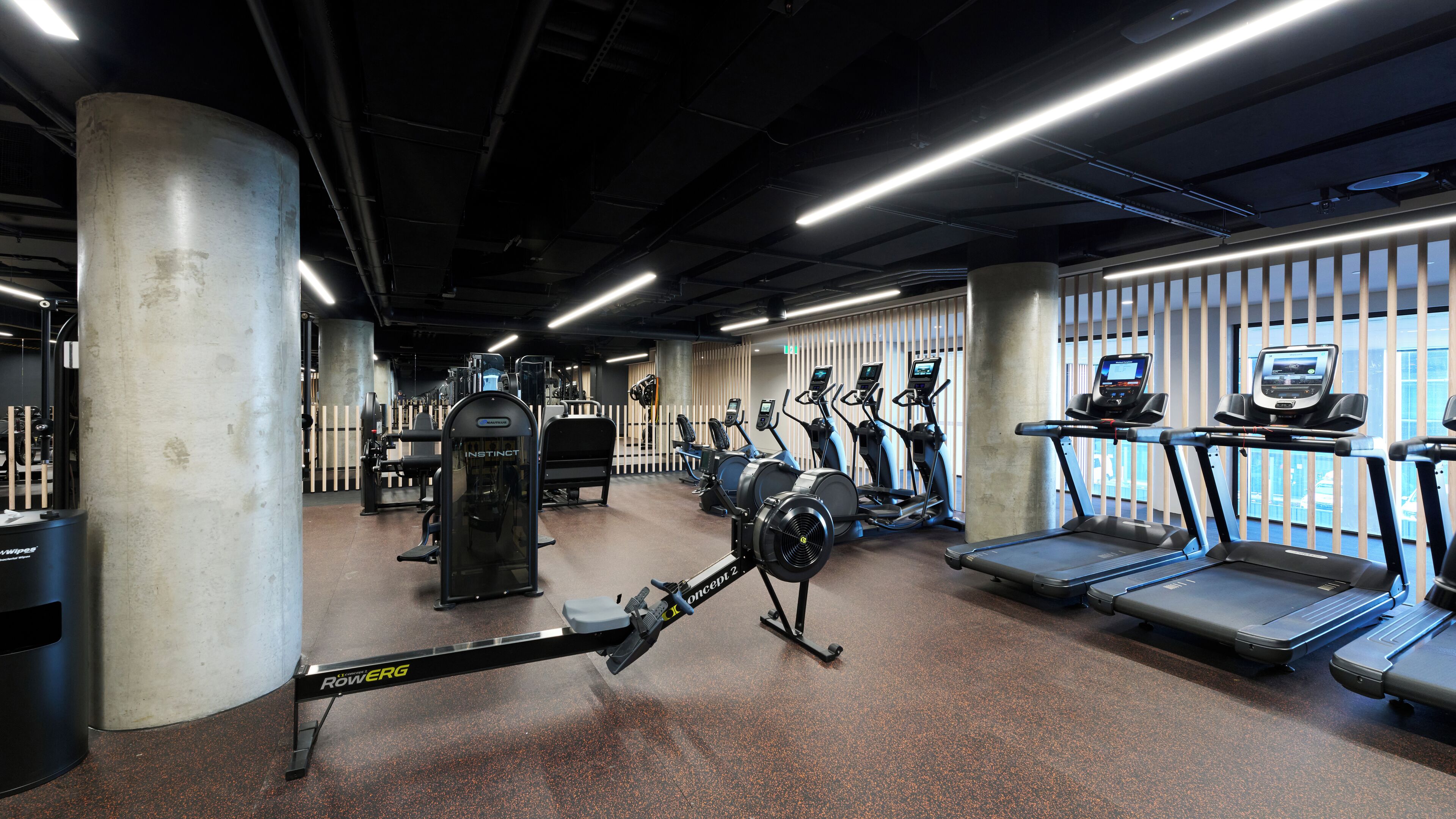 A gym with various exercise equipment, including treadmills and weight machines.