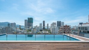A rooftop pool with a city skyline view. - Rose Sea Hotel & Apartment (Da Nang)