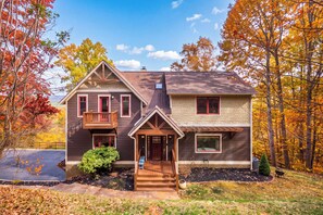 A two-story house with a front porch, a garage, and a small front yard.