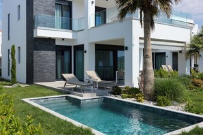 A modern two-story house with a swimming pool, outdoor seating, and a well-maintained garden. - Olympiada Residential Complex & Villas (Pangaio)