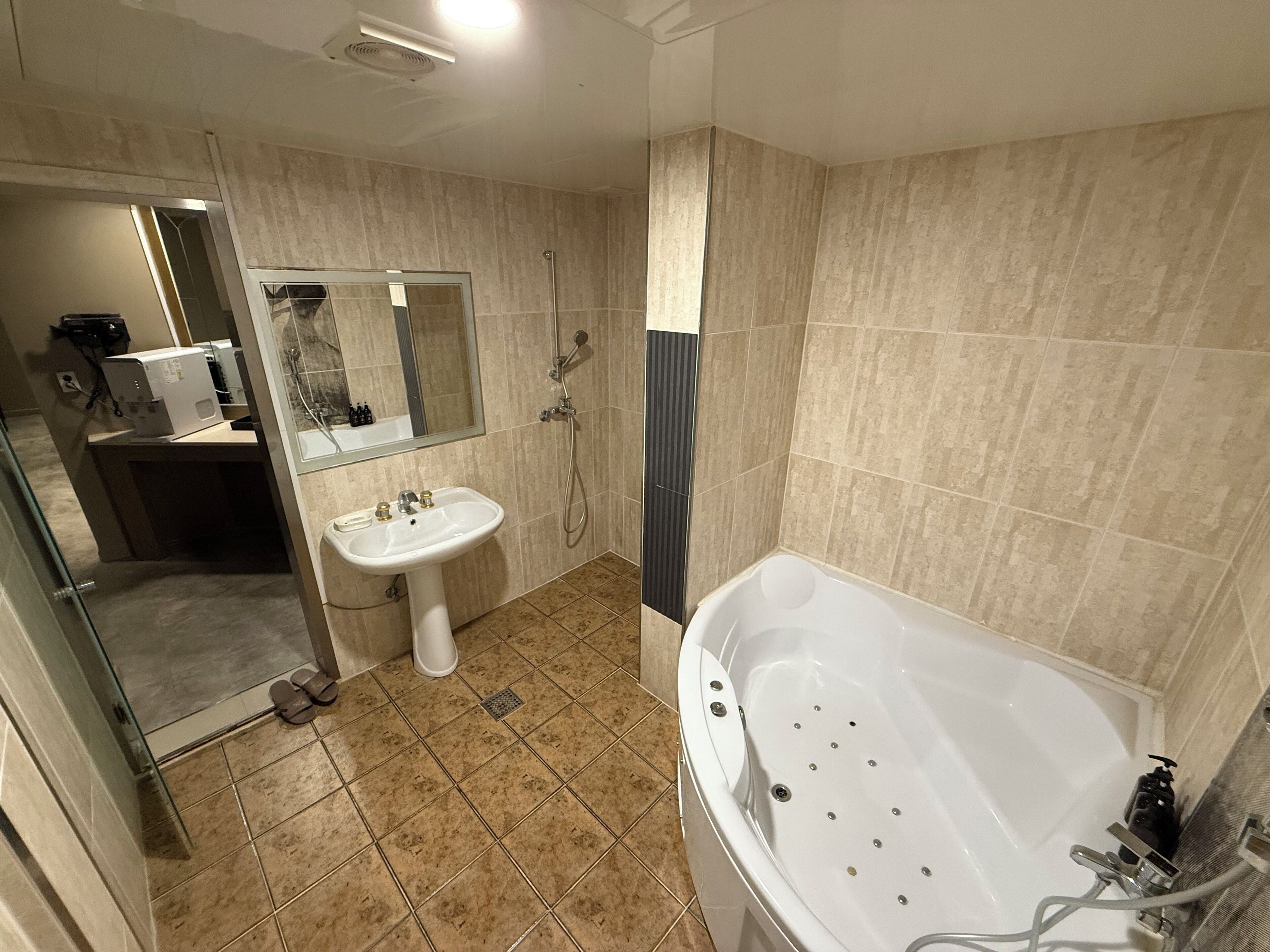 A modern bathroom with a bathtub, a sink, and a shower.