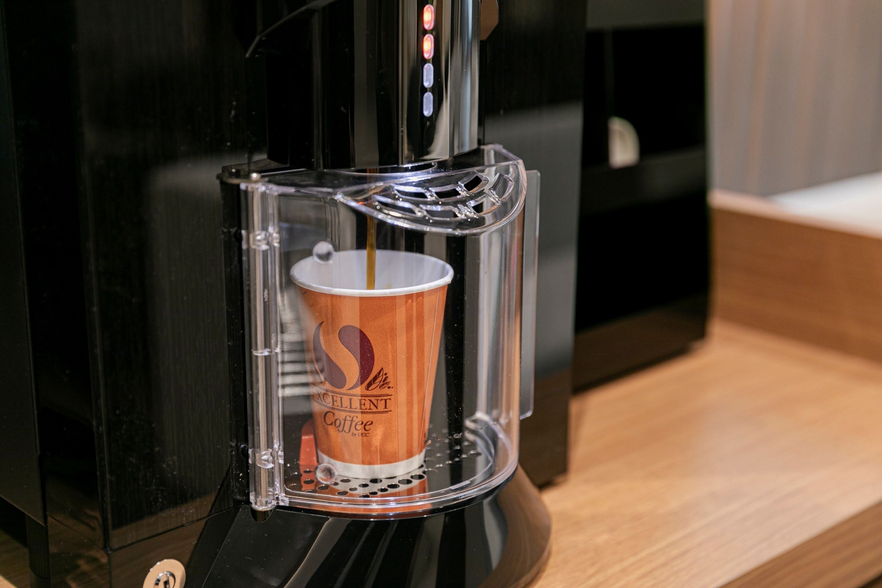 Una cafetera sirviendo café en una taza.