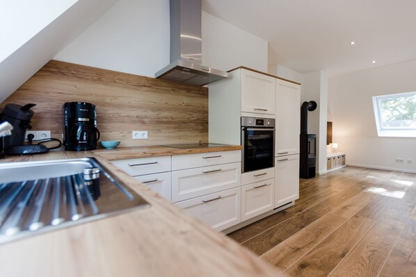 Fridge, stovetop, dishwasher, coffee/tea maker