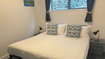 2 bedrooms, blackout drapes, soundproofing, iron/ironing board