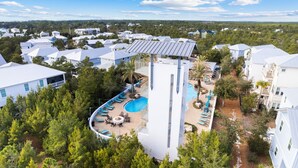 A resort with a pool area, multiple buildings, and surrounding greenery.