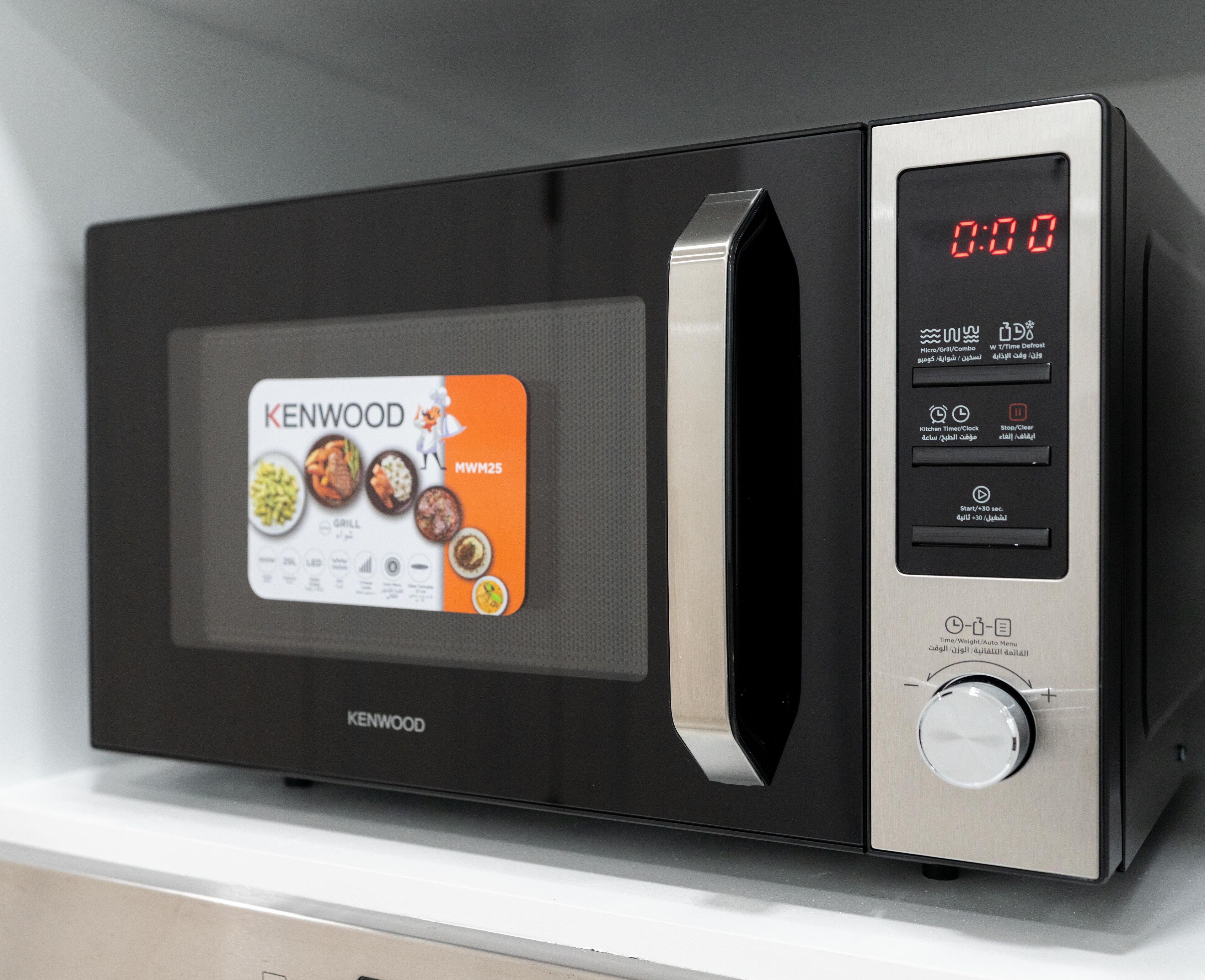 A Kenwood microwave with a digital display, control panel, and a menu screen.