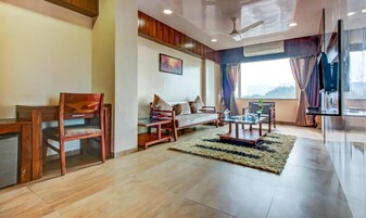 Premier Room | Living area | 144-inch LCD TV with cable channels
