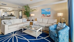 A living room with two sofas, a coffee table, and a ceiling fan. - Sun, Sand and Sea Views 3 Bdrm Condo with Balcony (North Myrtle Beach)