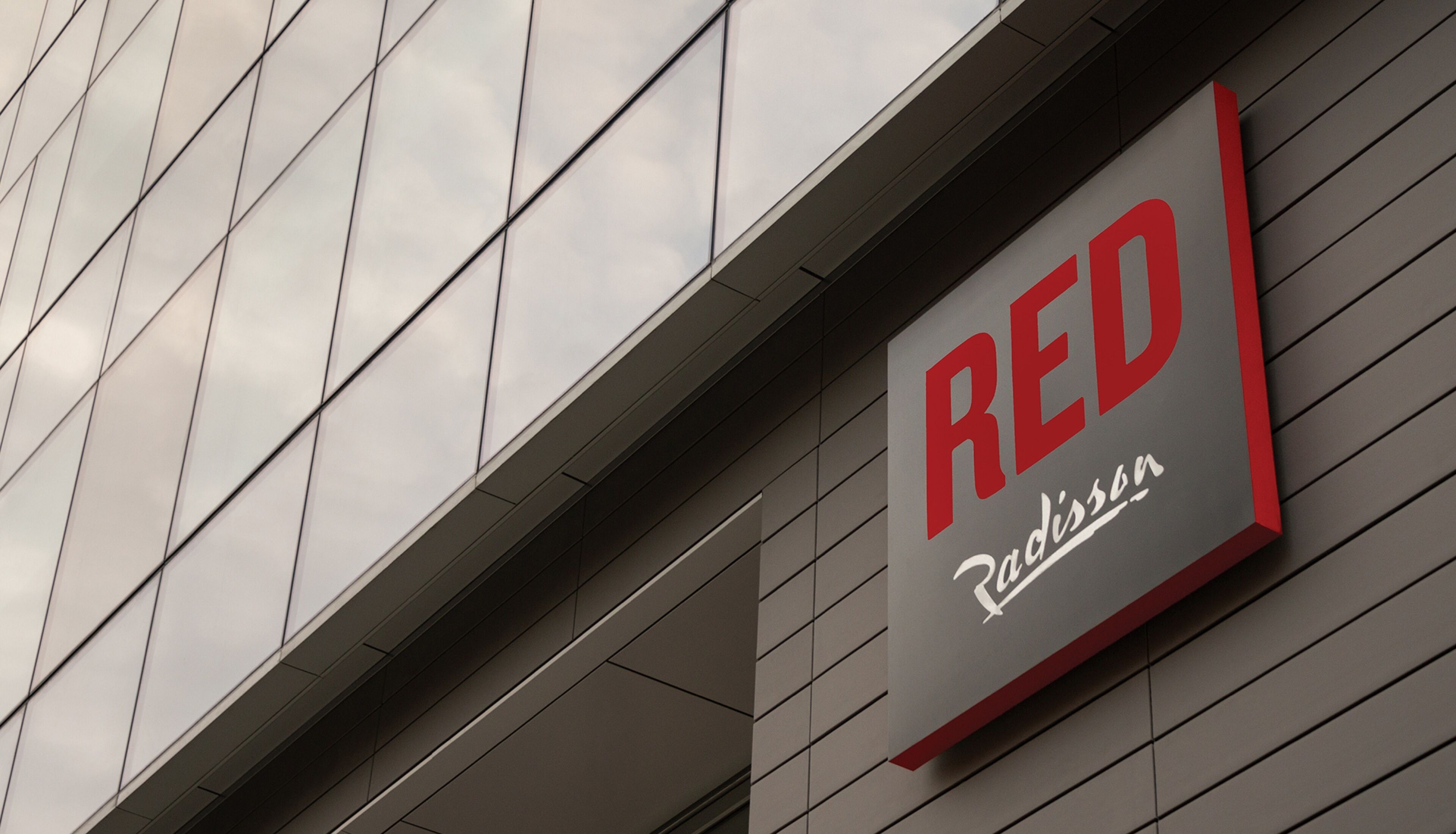 A building facade with a sign that reads "RED Radisson."