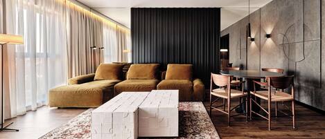 Una sala de estar moderna con un sofá modular, una mesita de centro y un comedor con sillas y una mesa.