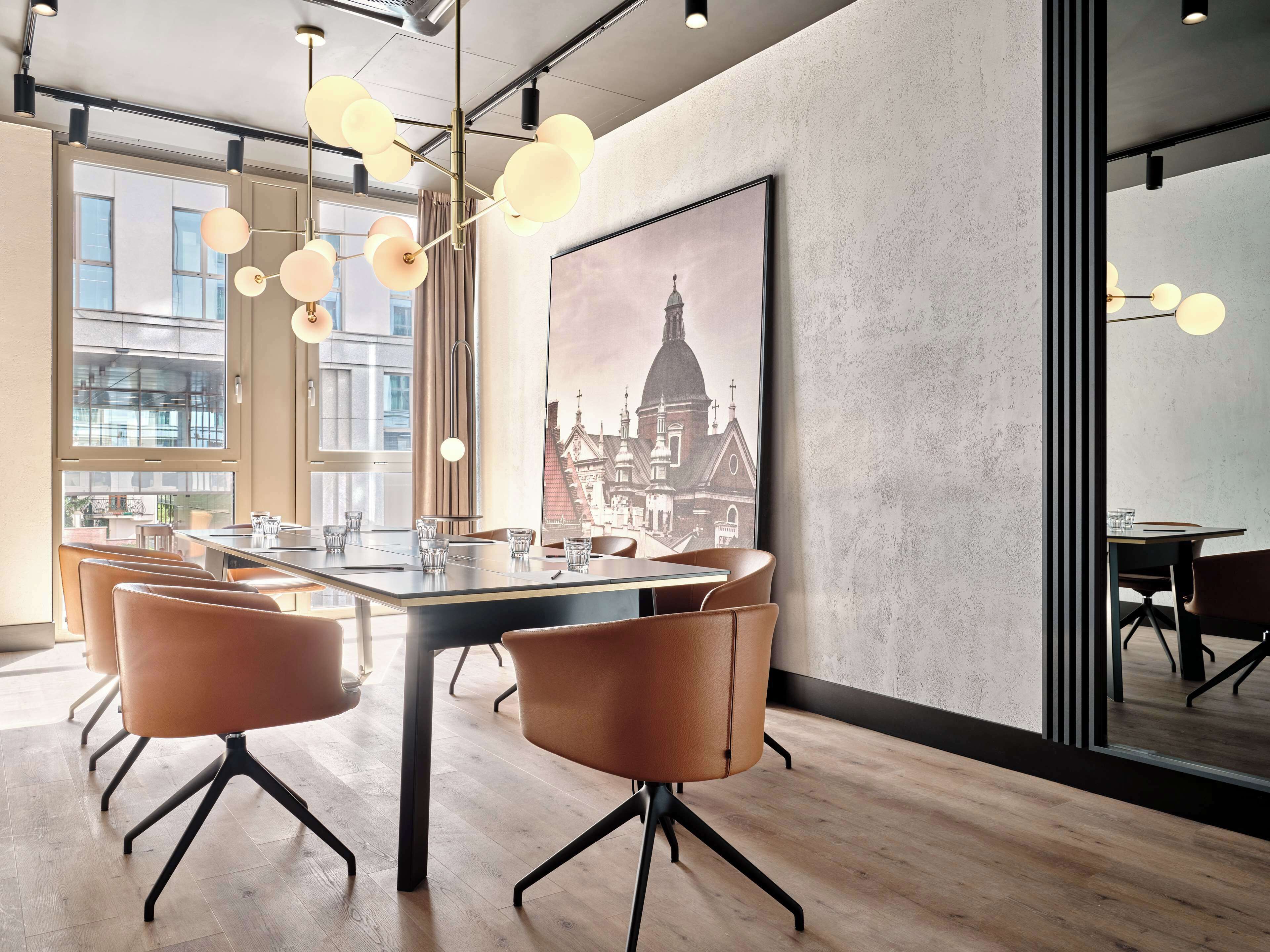 A modern conference room with a large table, leather chairs, and a cityscape painting on the wall.