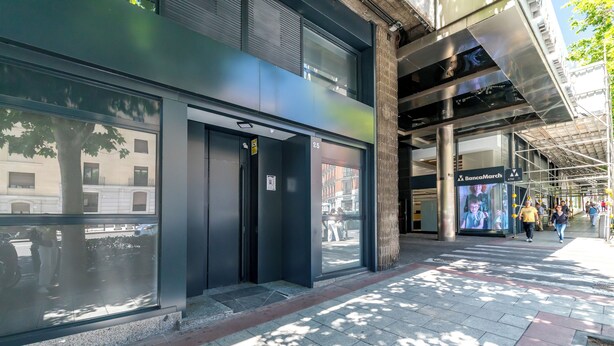 A modern building facade with large windows and a door labeled "BancaMarch." - AYZ Princesa - Auto check-in property (Madrid)