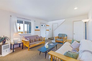 Relax in a spacious living area with a comfortable seating area and a staircase leading to additional living space.