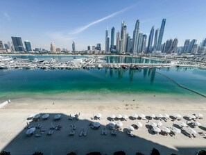 Enjoy the marina views and beachside relaxation with sun loungers and umbrellas.