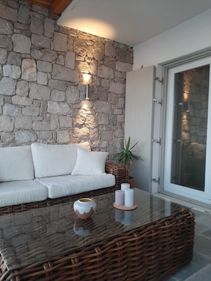 Relax in a comfortable seating area with a sofa and coffee table, surrounded by a potted plant and decorative accents.