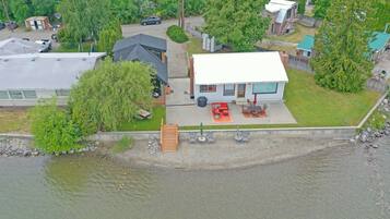 A house with a patio, a garage, and a small shed.