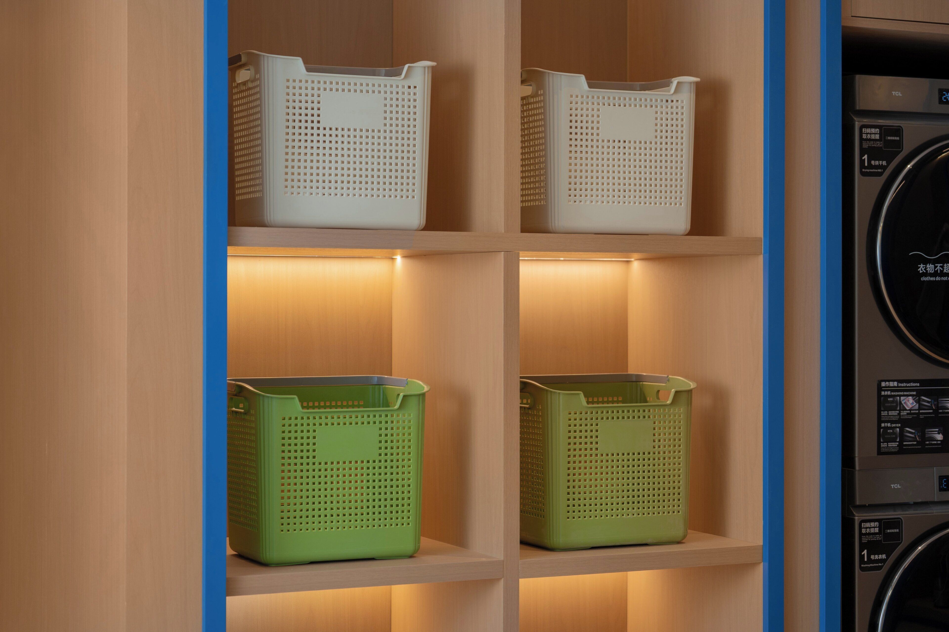 A laundry area with shelves holding baskets and a washing machine.