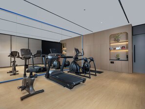 A modern gym with cardio machines, a treadmill, and a mirrored wall. - Holiday Inn Express Luoyang Nanchang Road by IHG (Luoyang)