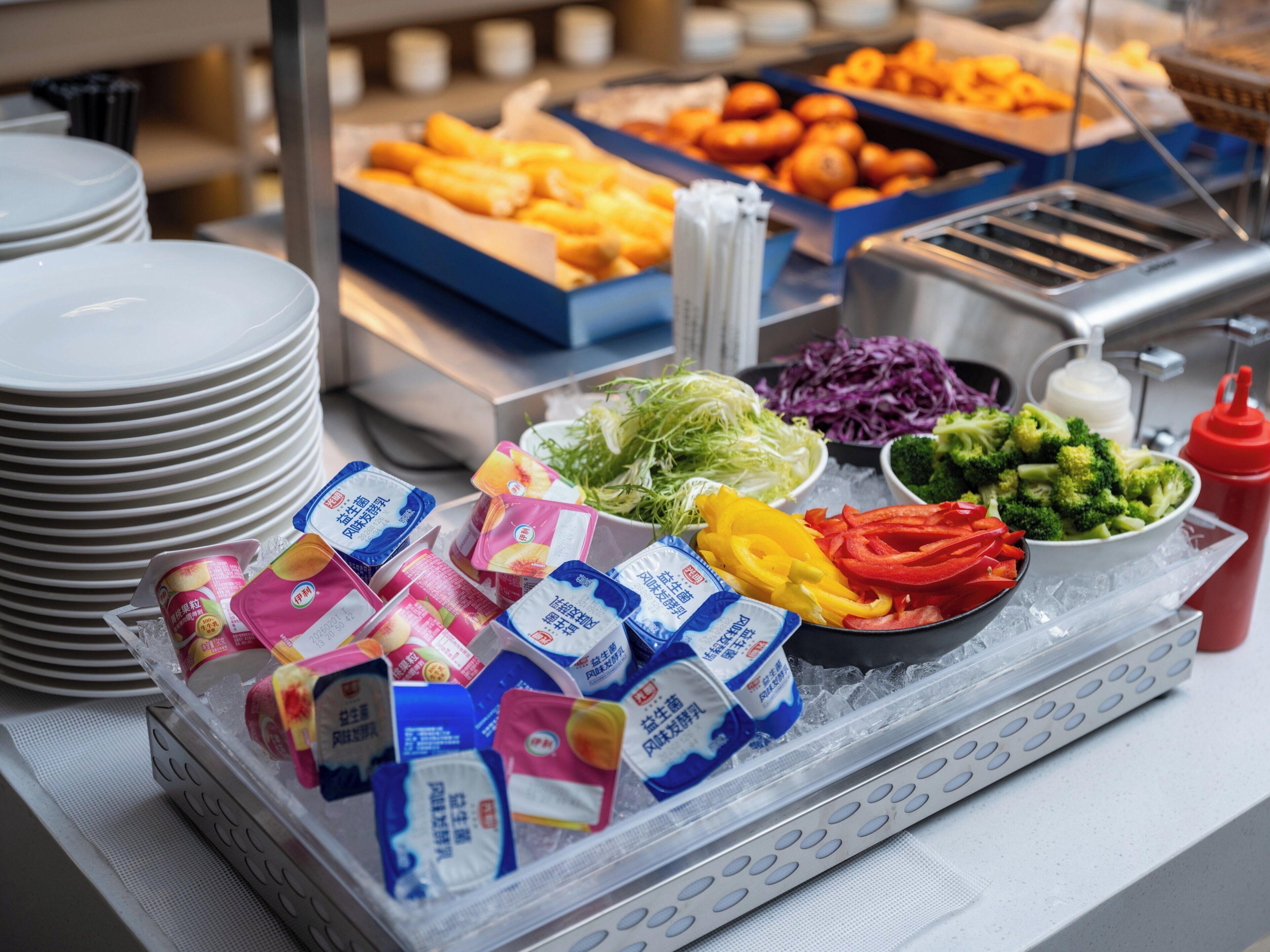 A buffet with various food items and condiments.