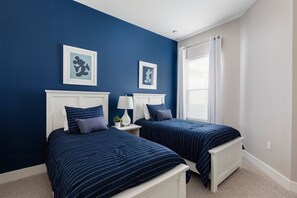 A bedroom with two beds, white headboards, and blue walls. - 4 BR 4 BA Villa 5min Disneyworld 1804ft BBQ (Kissimmee)