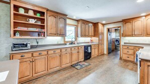 A spacious kitchen with wooden cabinets, a built-in oven, and a dishwasher. - Spacious Mount Pleasant Home w/ Grill & Yard! (Mount Pleasant)