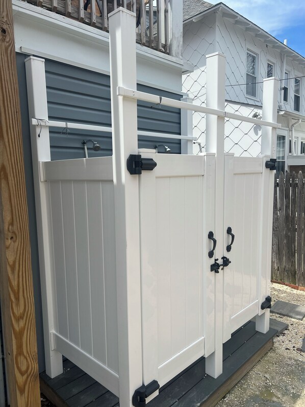 A white metal gate with two black handles and a metal latch. - Great condo 2.5 blocks from the boardwalk very clean with upgraded appliances (Wildwood)