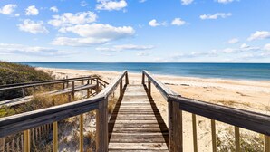 A wooden boardwalk leading to a beach with clear skies and calm water. - Rising Sun: Cozy 2 BR Beachfront Home on East End- Sleeps 8, Pet Friendly! (St. George Island)