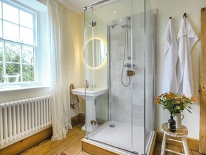 A modern bathroom with a glass-enclosed shower, a white sink, and a wooden floor. - 2 bedroom accommodation in Ludlow (Ludlow)
